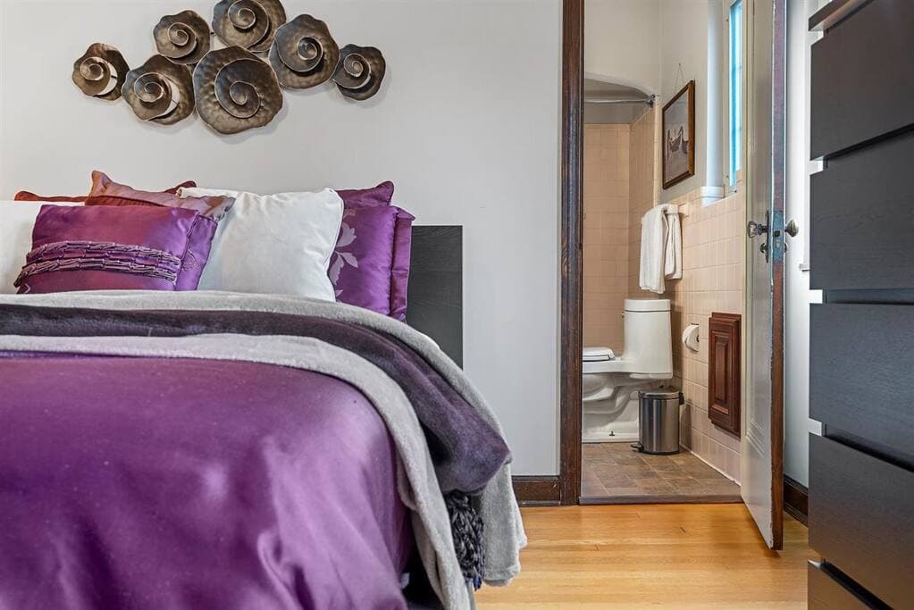 Downstairs bedroom with the door leading into the full bath