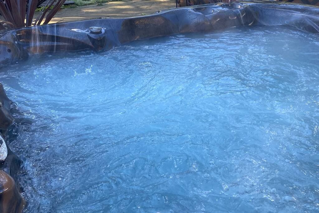 PRIVATE Hot Tub surrounded by beautiful gardens and privacy fence.