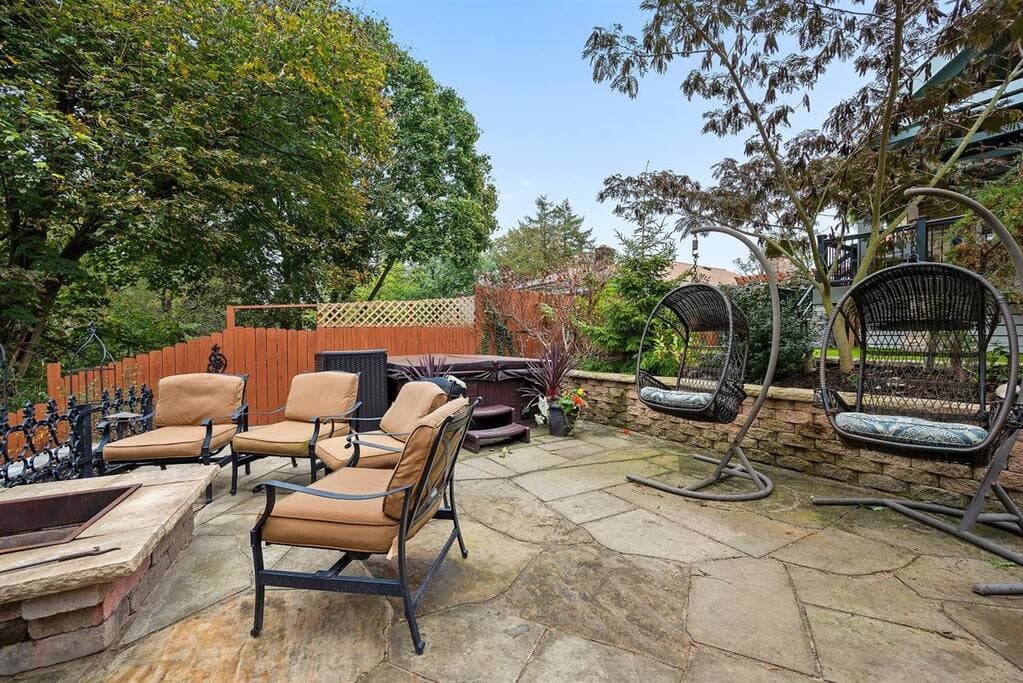 Hot tub, pod chairs, and seating around the natural fire pit.  You will love the outdoor space here!