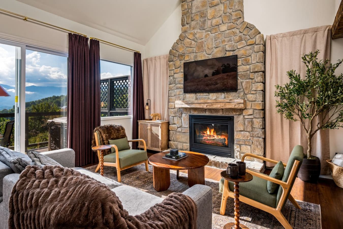 Sunlight pours through the open windows, filling the cozy mountain living room with warmth and the scent of pine.