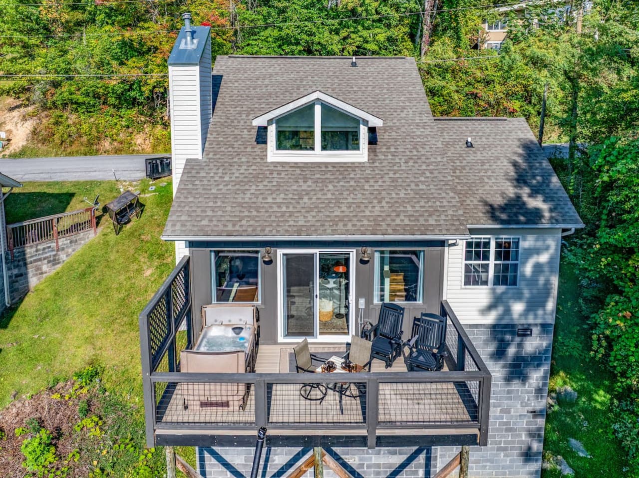 The cabin’s exterior boasts a charming rustic design with a spacious balcony that perfectly frames the breathtaking panoramic views of the Smoky Mountains, providing an ideal spot to soak in the natural beauty.