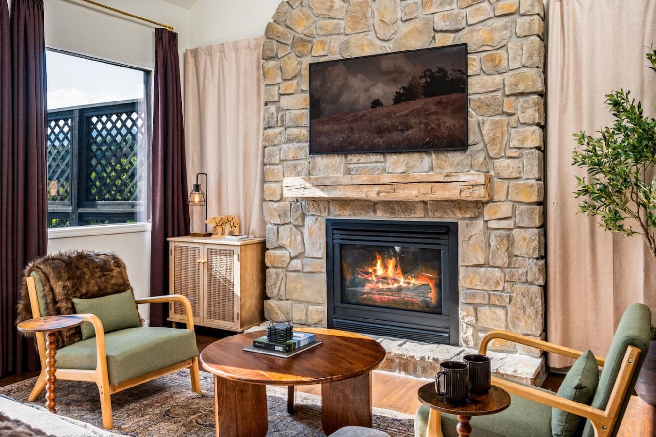 The Smoky Mountain views stretch beyond the windowpanes, blending perfectly with the room’s earthy, calming tones.