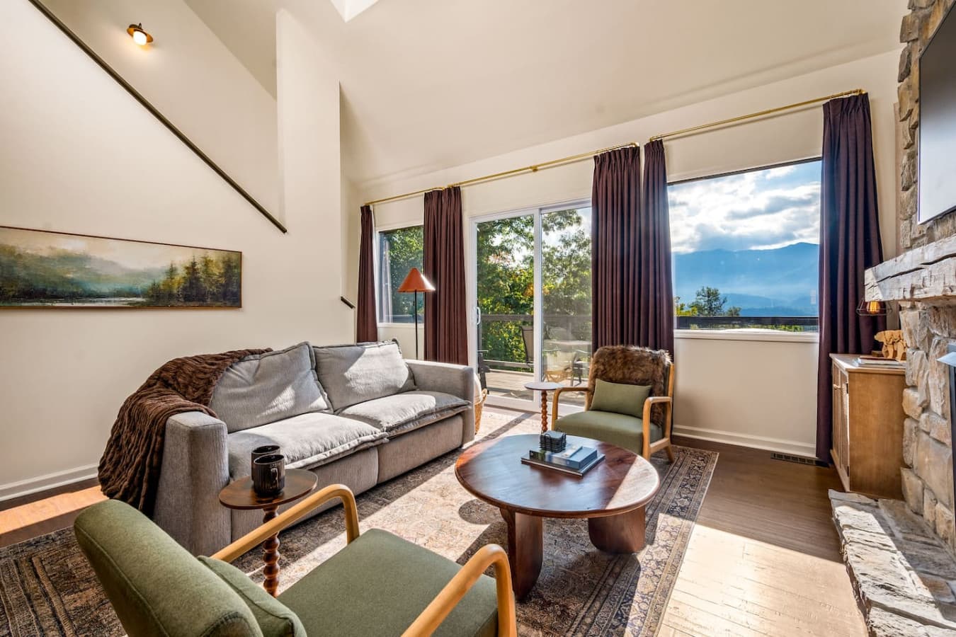 Plush blankets and woven textures invite relaxation as cool mountain air drifts in from the open windows.