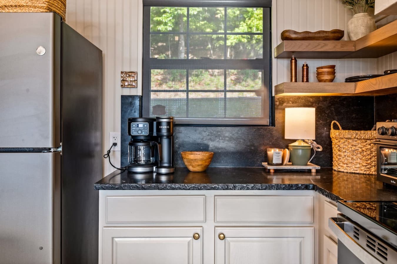 A coffee machine and toaster oven sit neatly on the counter, ready for slow mountain mornings.