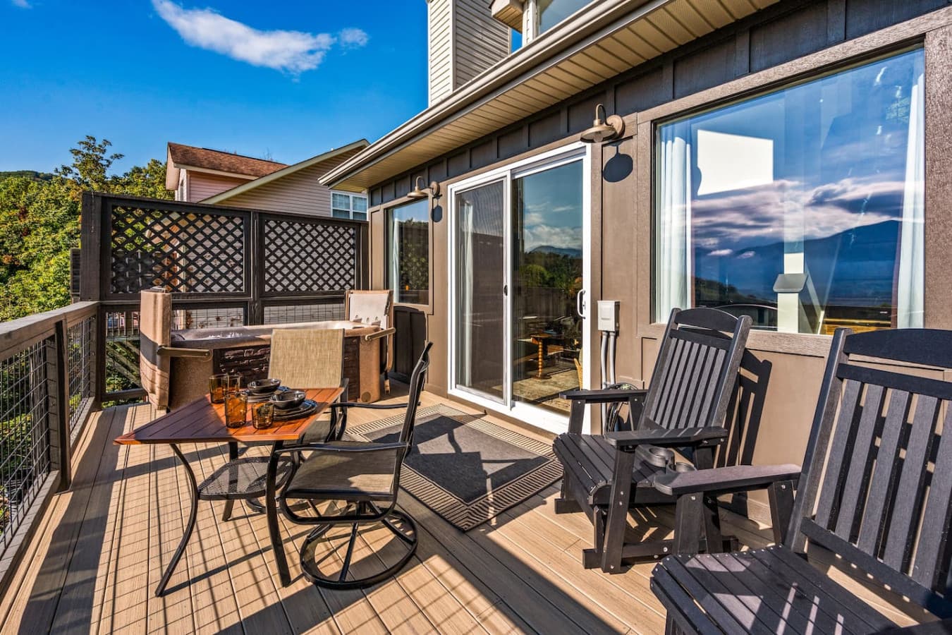 The balcony features a charming dining table and cozy relaxing chairs, all perfectly positioned to enjoy unobstructed views of the stunning Smoky Mountains.