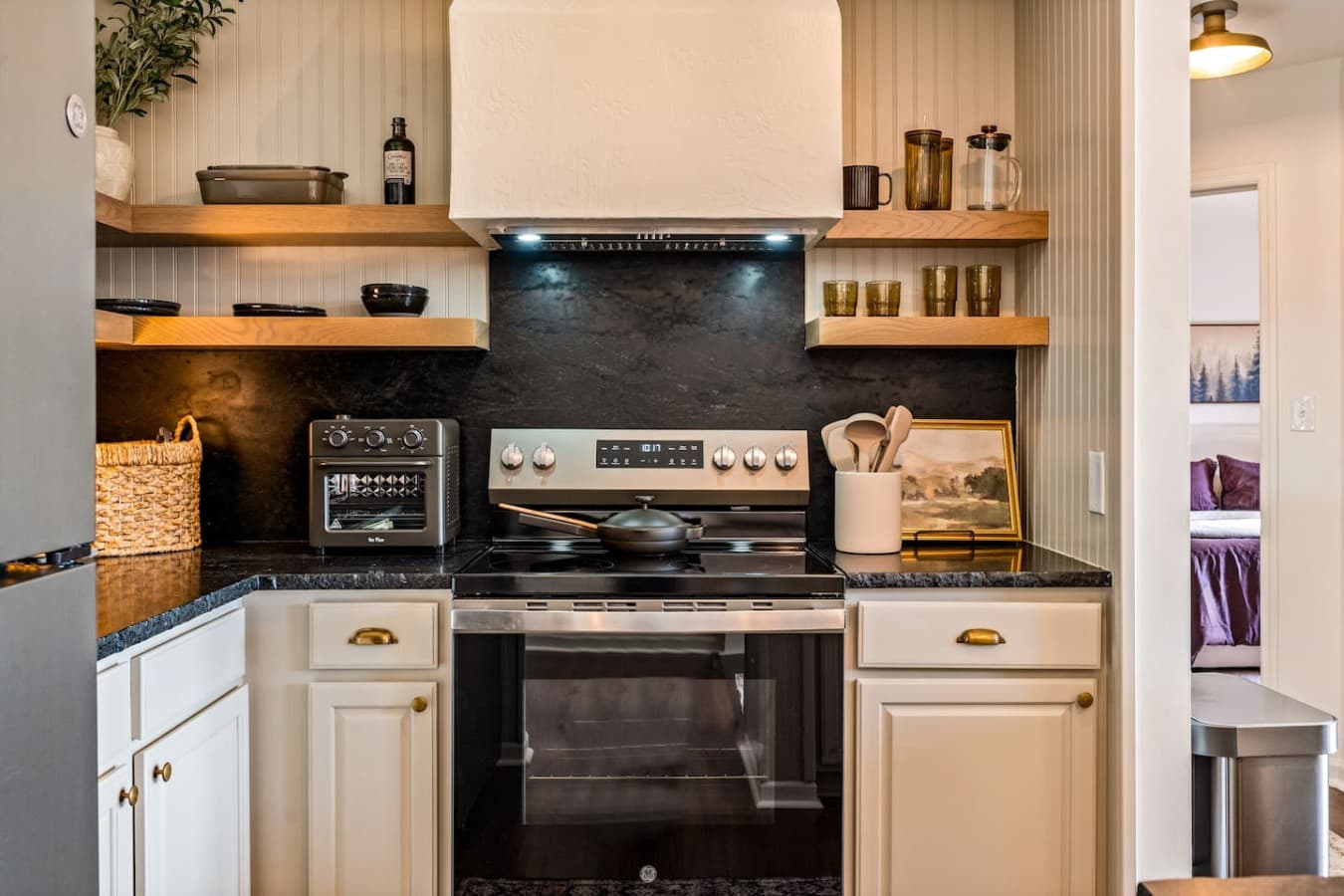 Sleek countertops and updated stainless-steel appliances make the space both beautiful and functional.