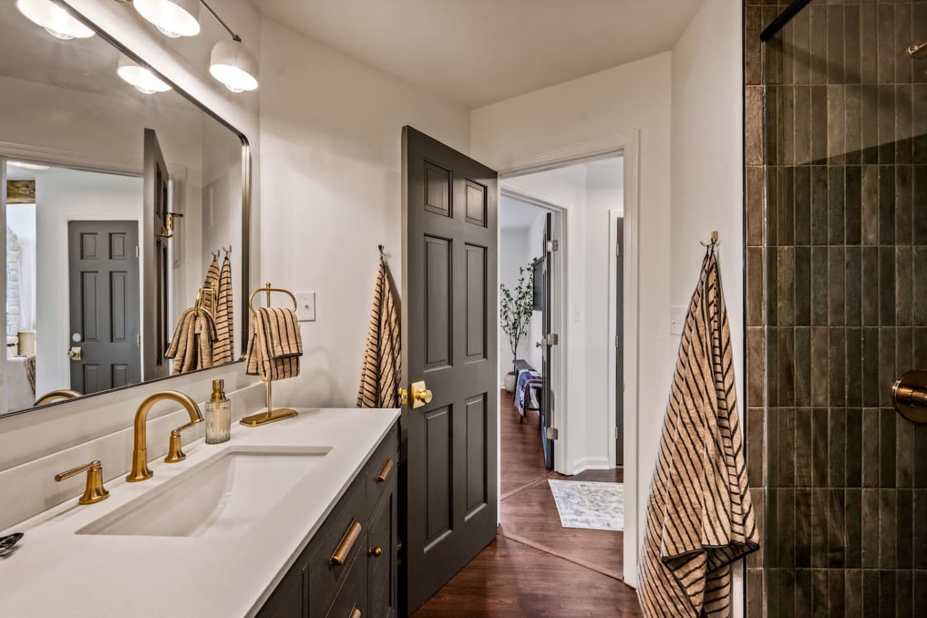 The master bath suite exudes modern luxury with a sleek walk-in shower featuring a soothing rain shower head.