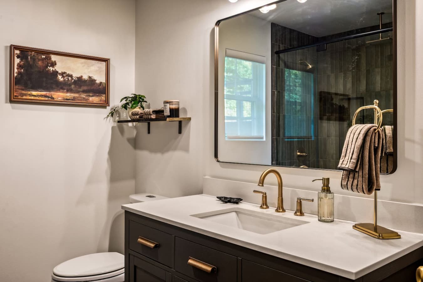 A stylish single vanity offers both function and flair, complemented by soft lighting and polished details.