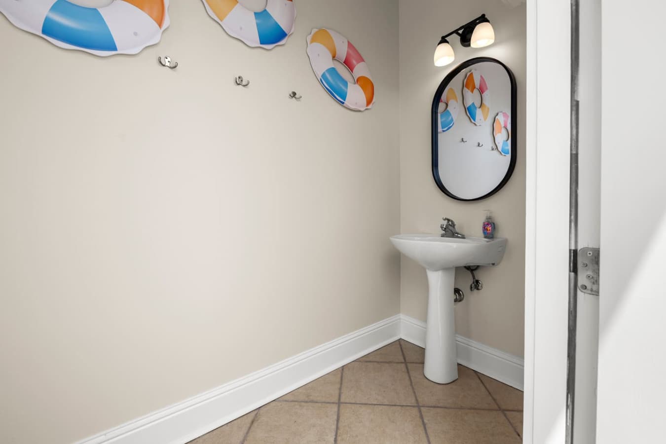 Half bath conveniently located close to the pool and hangout space