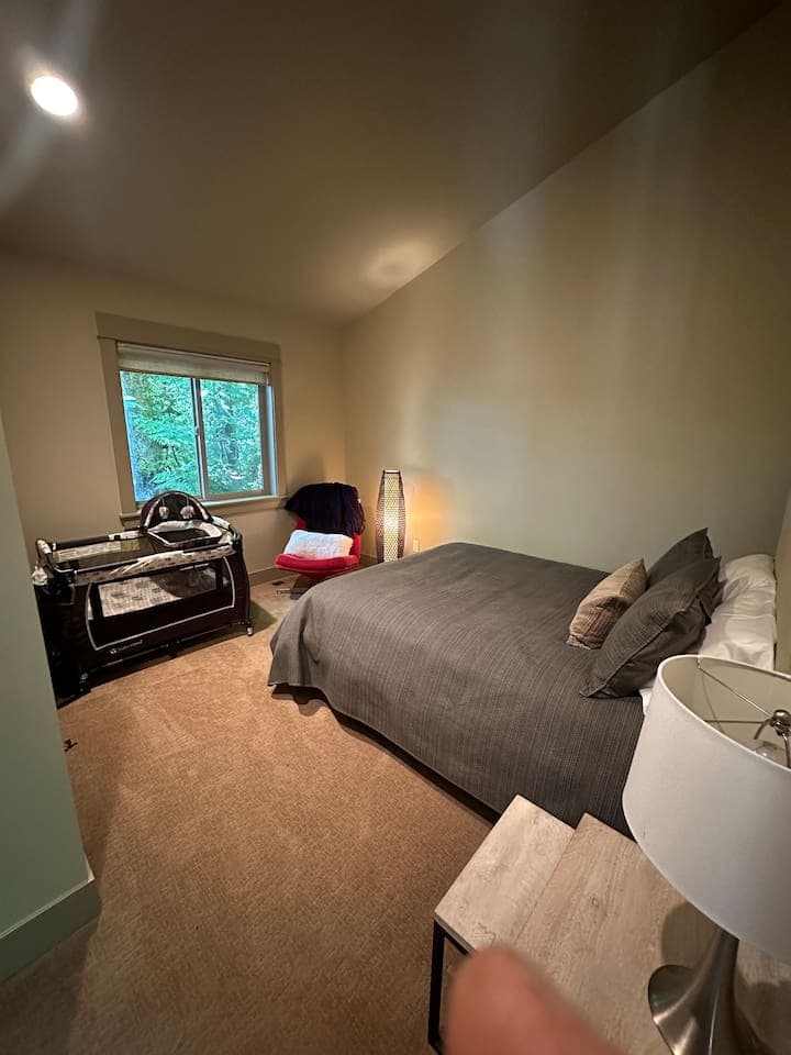 Queen bedroom featuring a portacrib that can be easily stored when not needed.