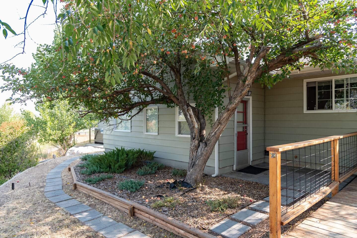 Beautiful plant life can be found throughout the property as shown at the back door that leads to the deck.
