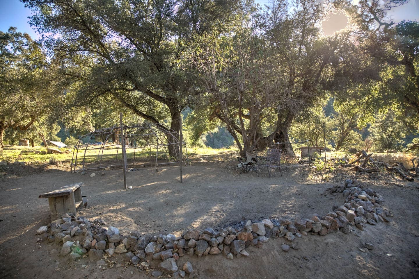 Fire ring with sweat lodge behind