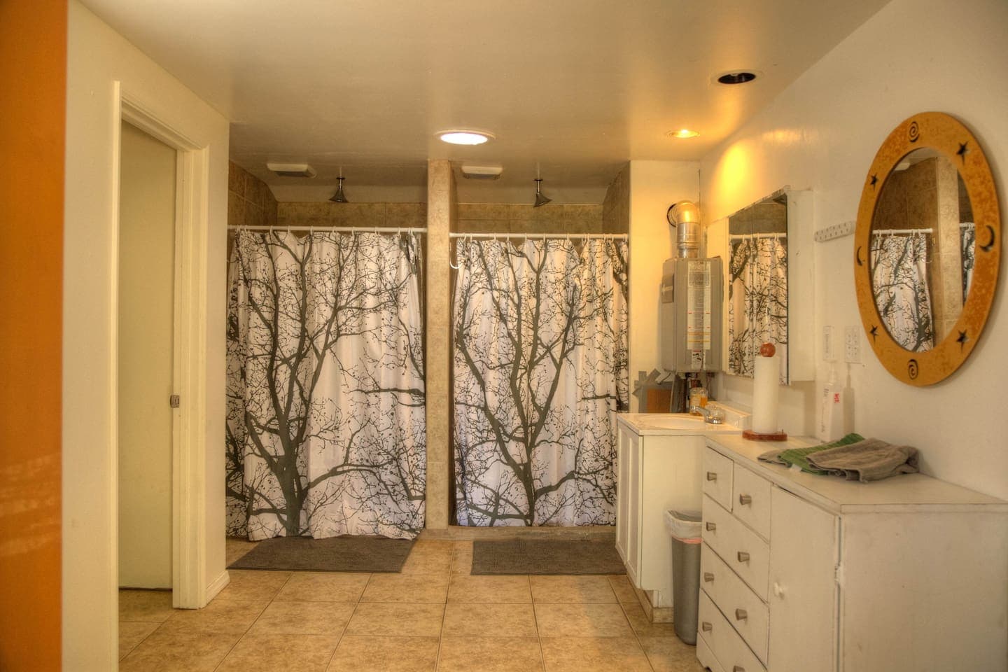 Bathroom with 2 closed door toilets and 3 shower stalls