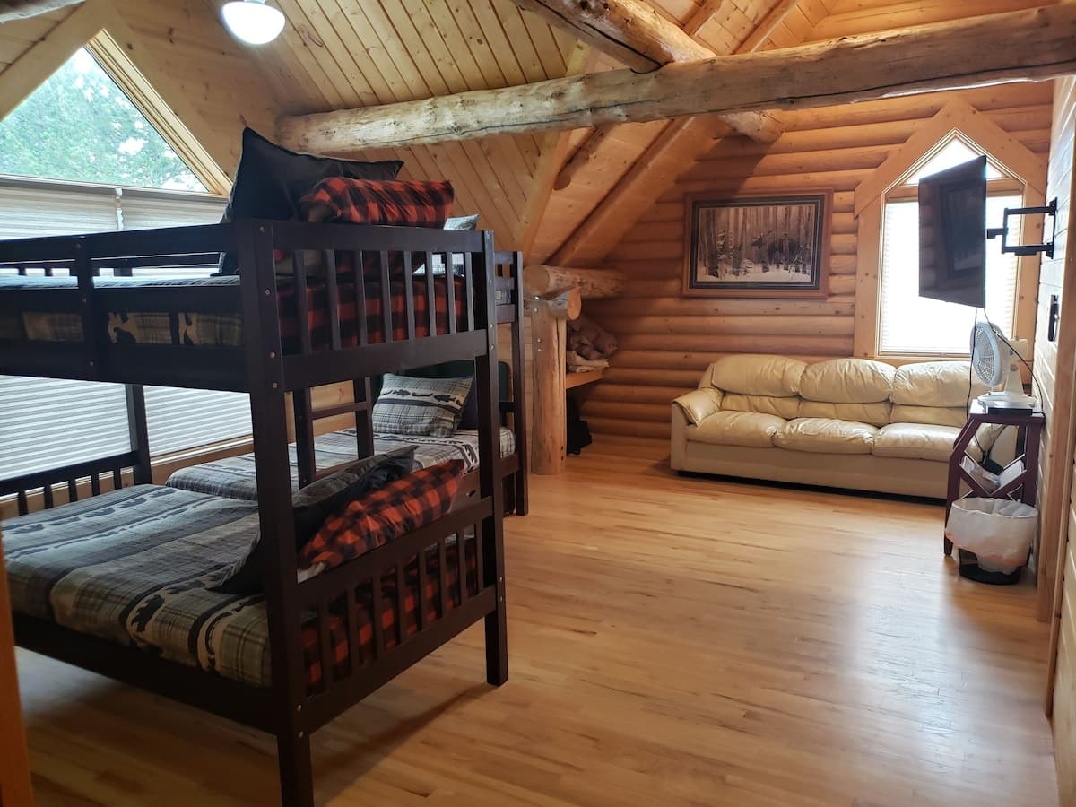 A TV and couch make the bunk room perfect for kids to hang out in.