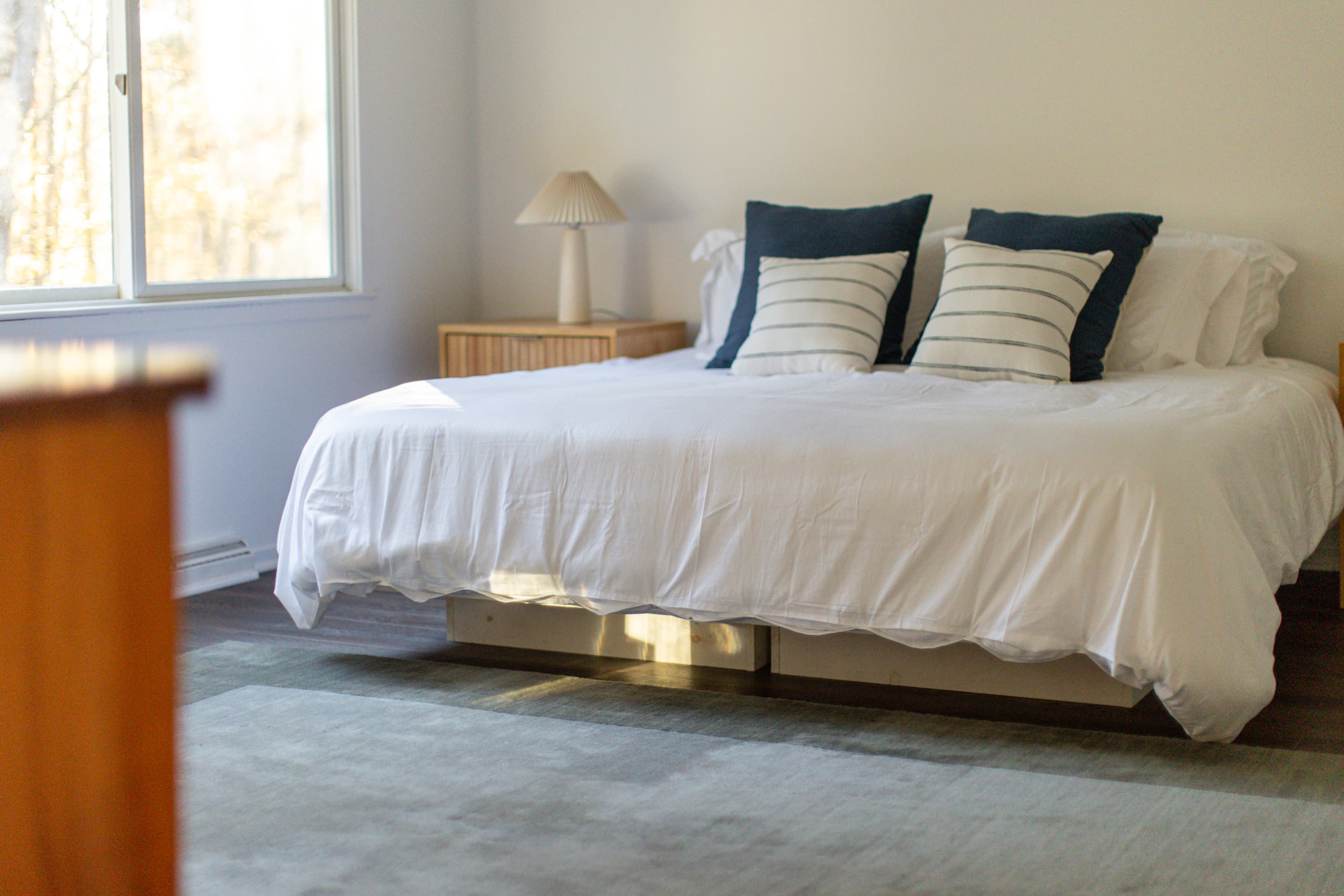 Primary Bedroom: Bright space featuring a comfy bed and lovely nature views. Perfect for relaxation!