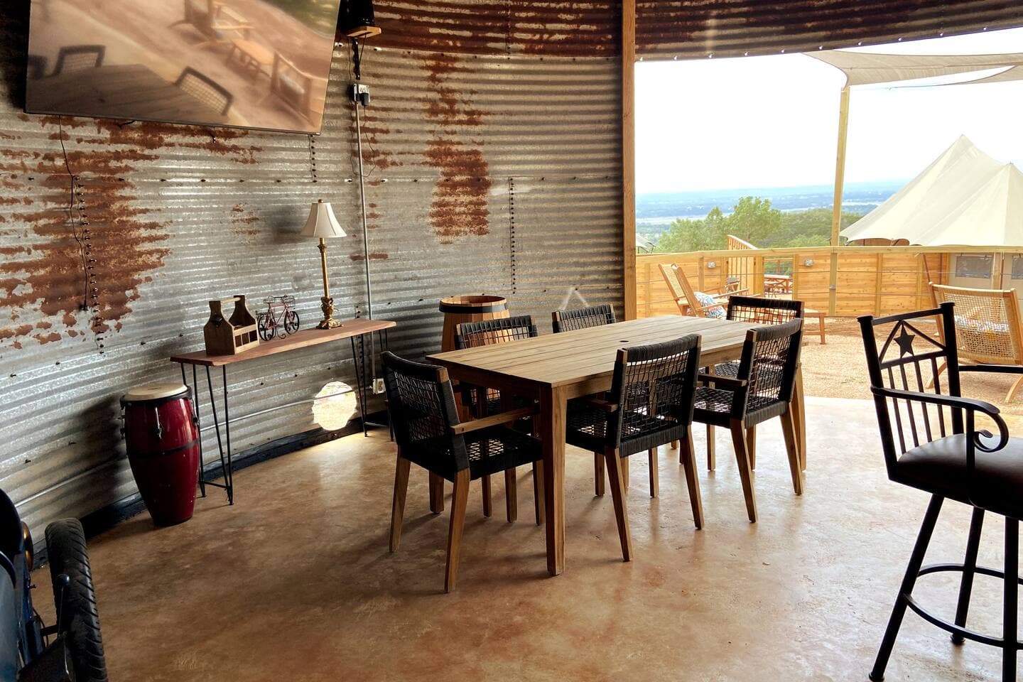 Binzebo at community area with dining table, bar, gas grill. hot tub, 75" TV and outdoor lounge area.