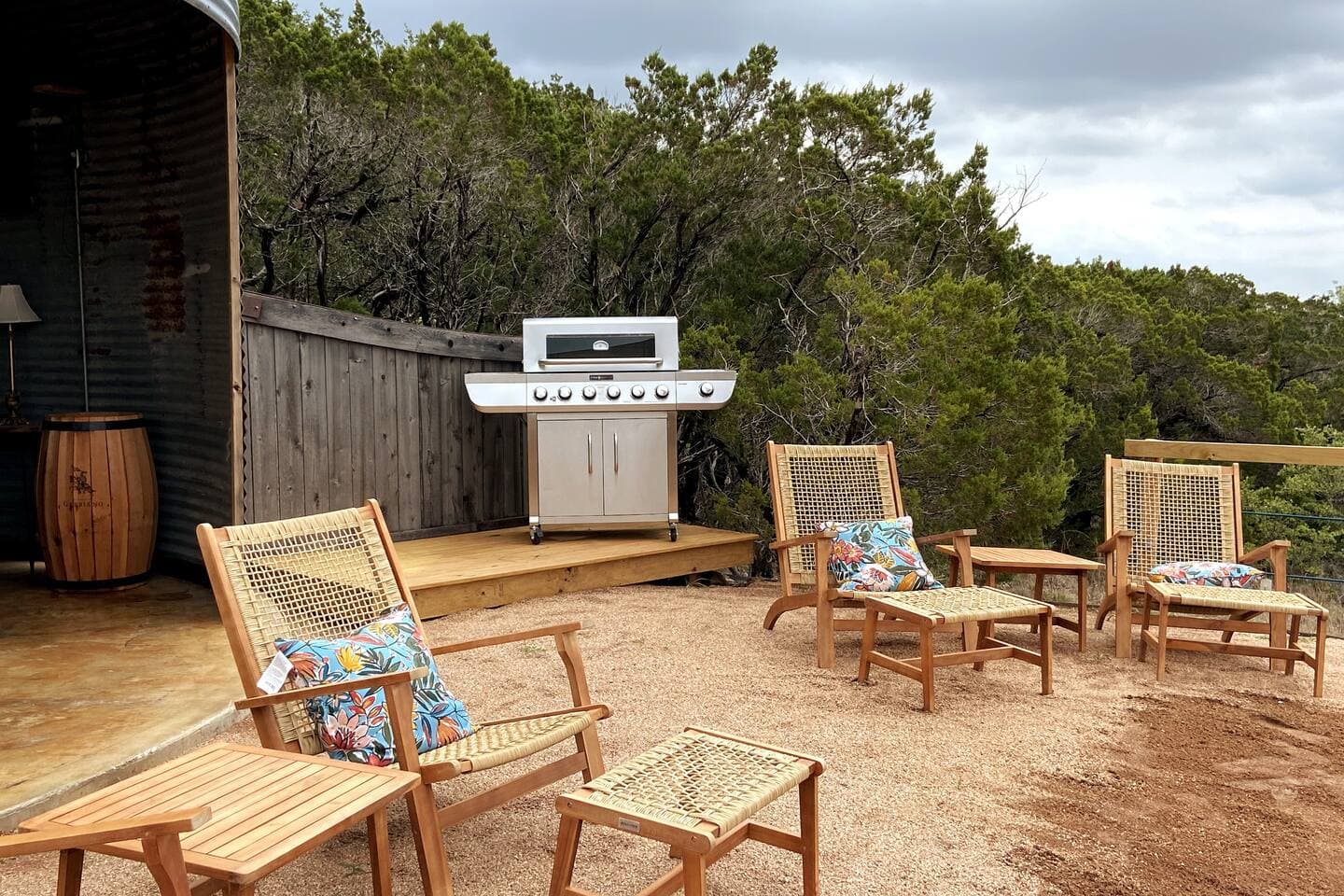 Binzebo at community area with dining table, bar, gas grill. hot tub, 75" TV and outdoor lounge area.