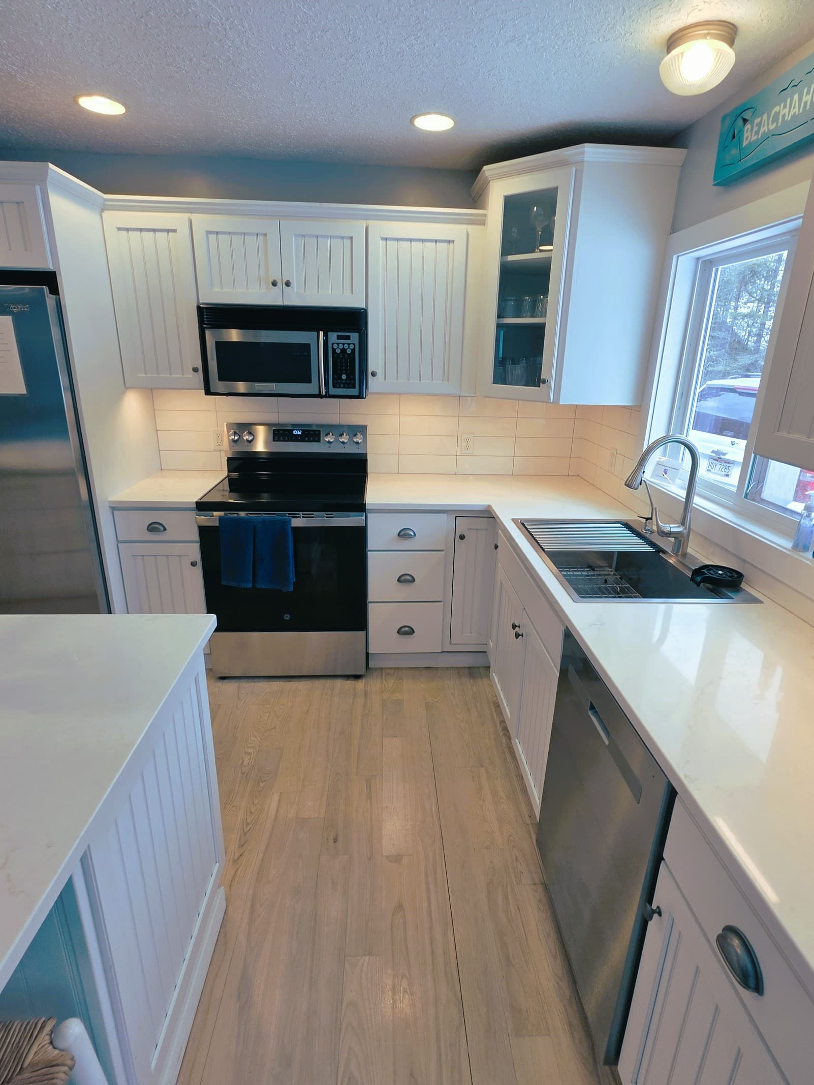 New kitchen Quartz counter tops and back splash 2026. Large bowl sink with glass wash and filtered drinking water.