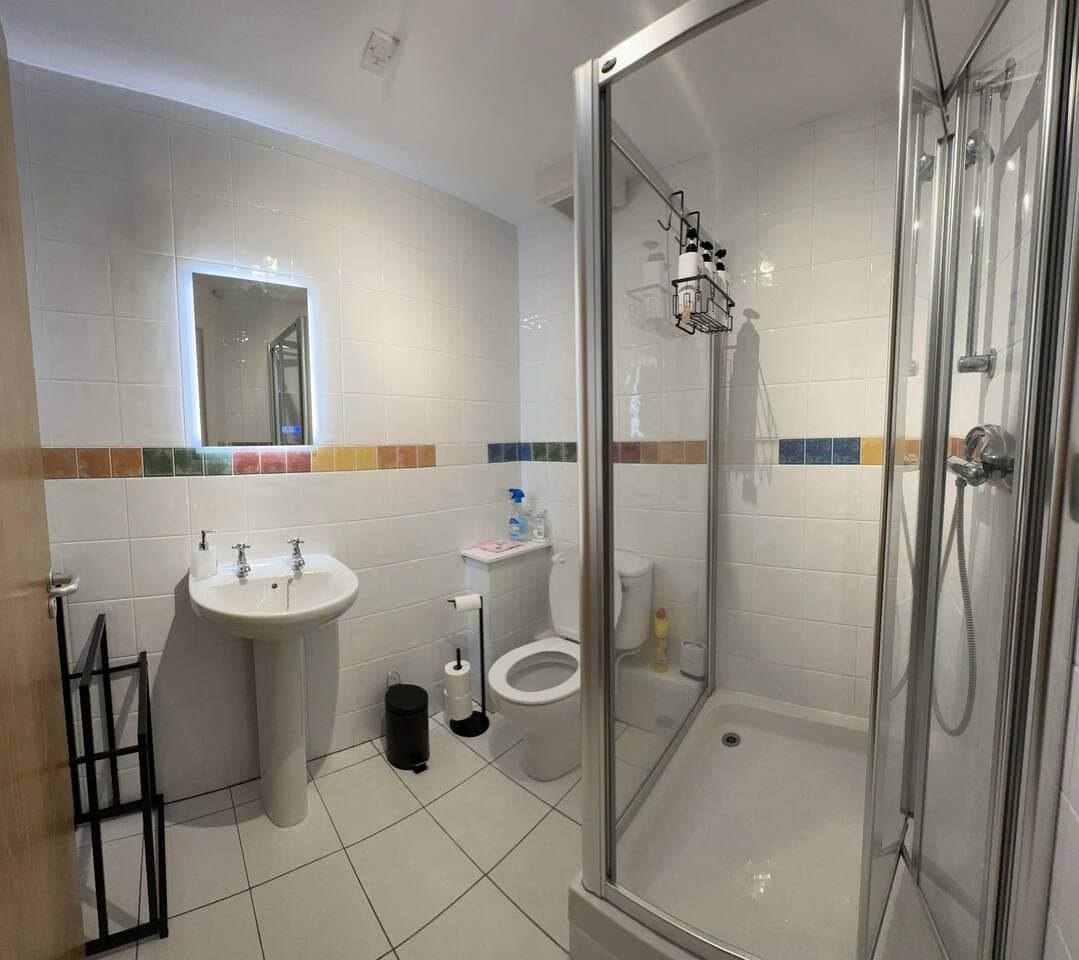 Master bedroom en-suite with shower and vanity mirror