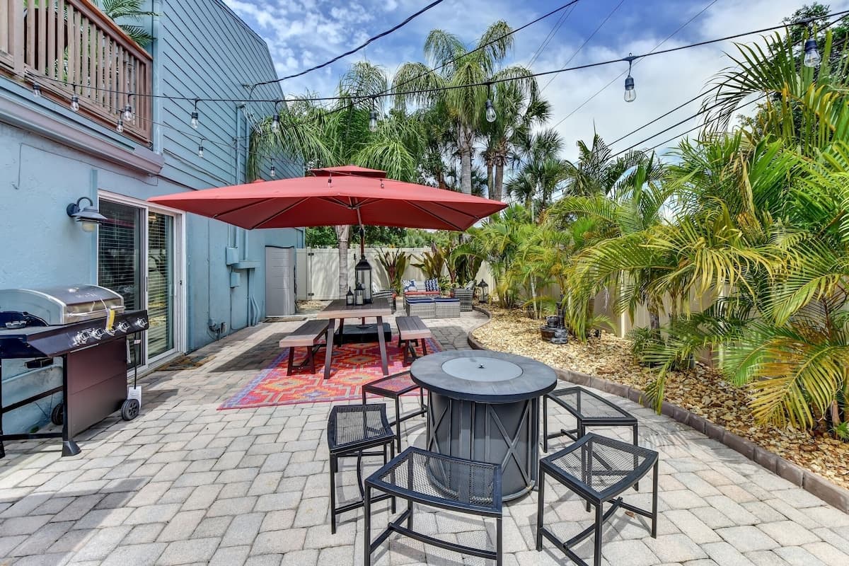 Private Fenced String-Lit Yard with Dining Table, Fire Pit, and BBQ Grill