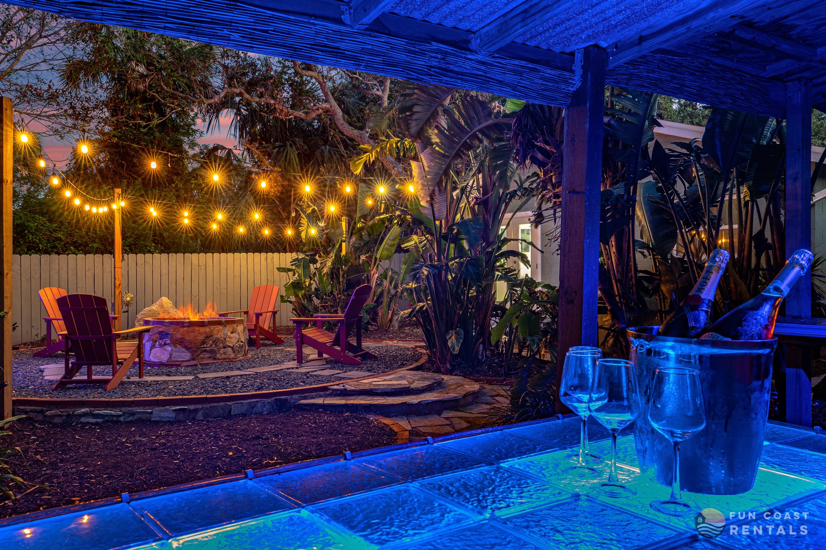 Private and inviting string lit zen Backyard with wood fire pit and bar!