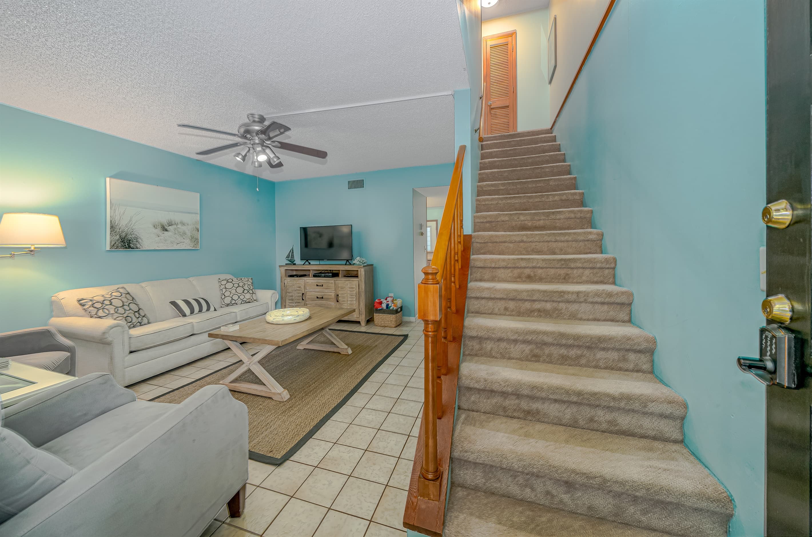 Living Room with Smart TV and Staircase to Bedrooms