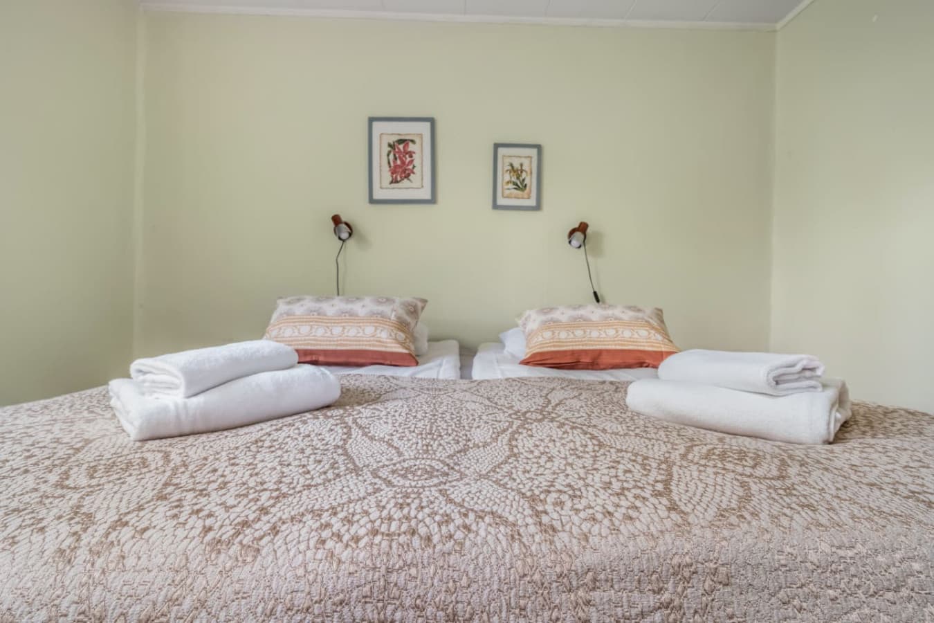 Rest easy in this bright, peaceful bedroom featuring soft linens, fresh towels, and tasteful decor.