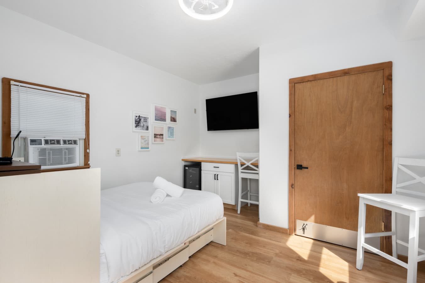First-level guest suite w/ queen Murphy bed, desk & wall-mounted TV — private exterior entrance, not connected inside to the main house