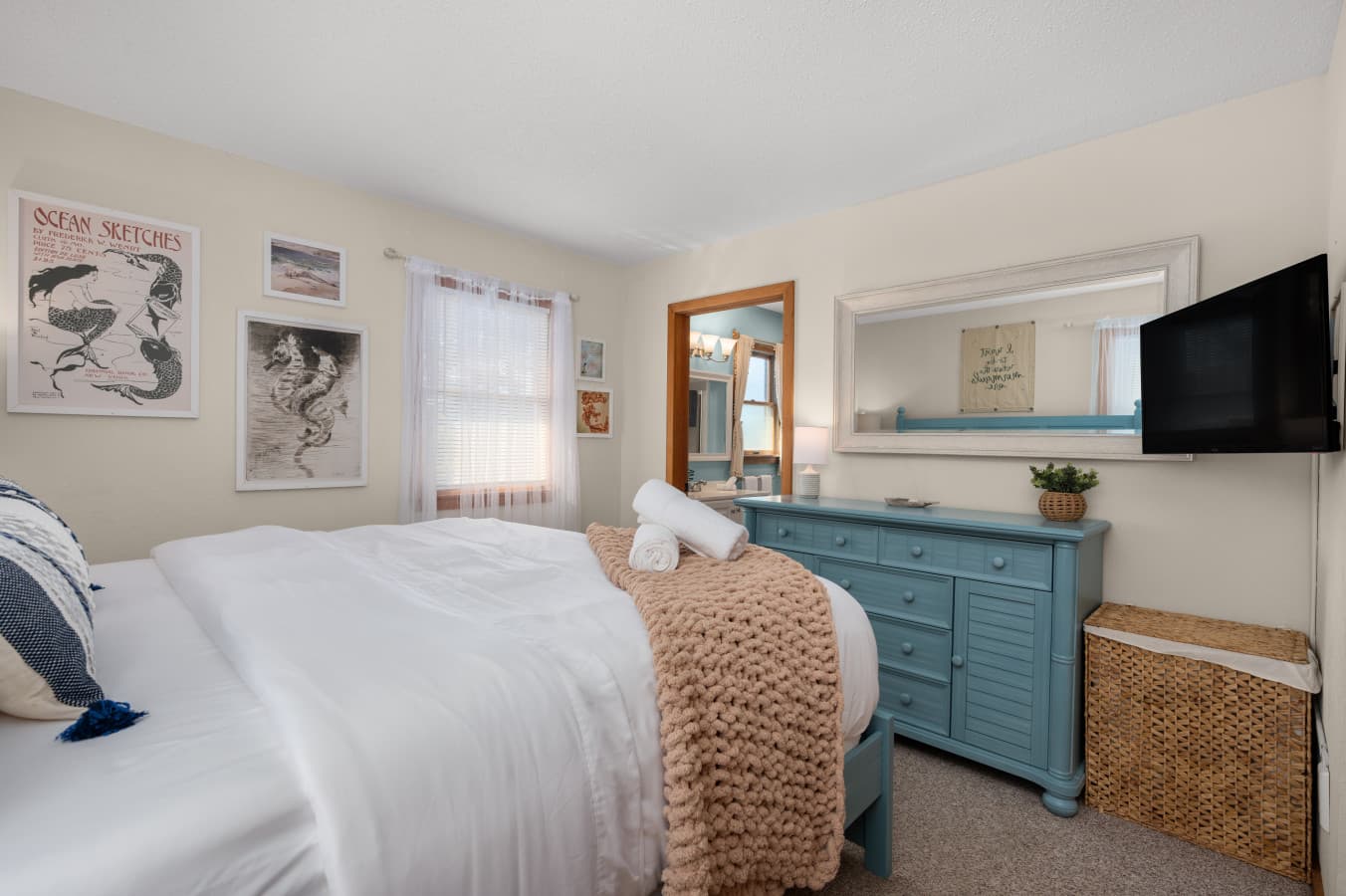 Spacious bedroom w/ dresser, TV & layered bedding for added comfort