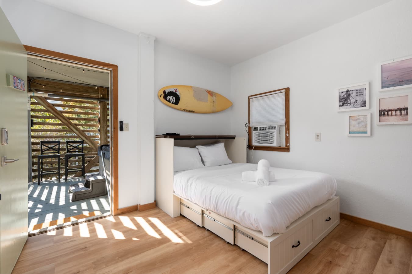 First-level guest suite w/ surfboard decor & natural light — accessed from outside via its own private entrance
