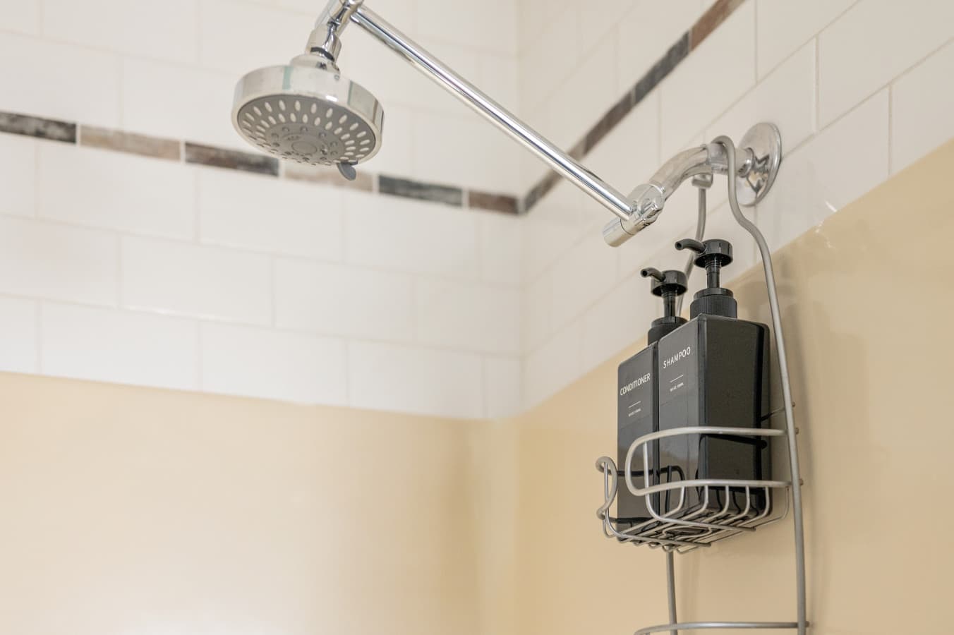Shower w/ tiled walls, rainfall head & mounted bath essentials