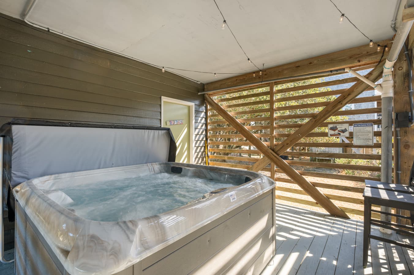 Covered deck w/ hot tub & privacy slats for a relaxing outdoor soak