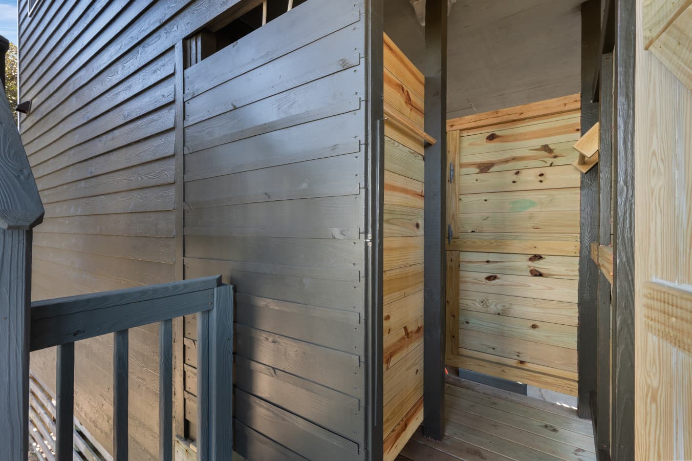 Outdoor shower entry w/ wood paneling for a quick rinse after beach days