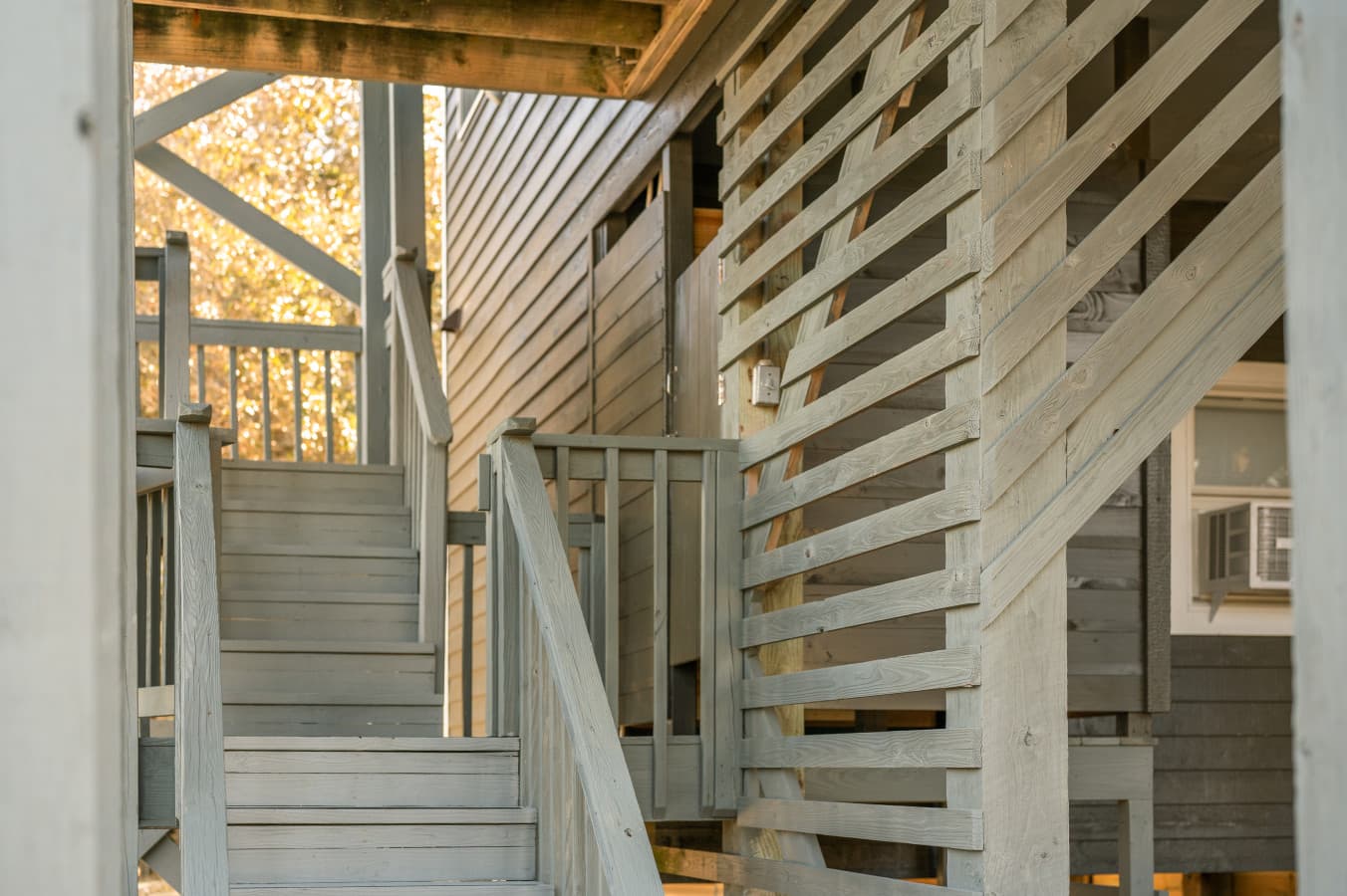 Exterior stairway leading up to the home, adding to its elevated coastal charm