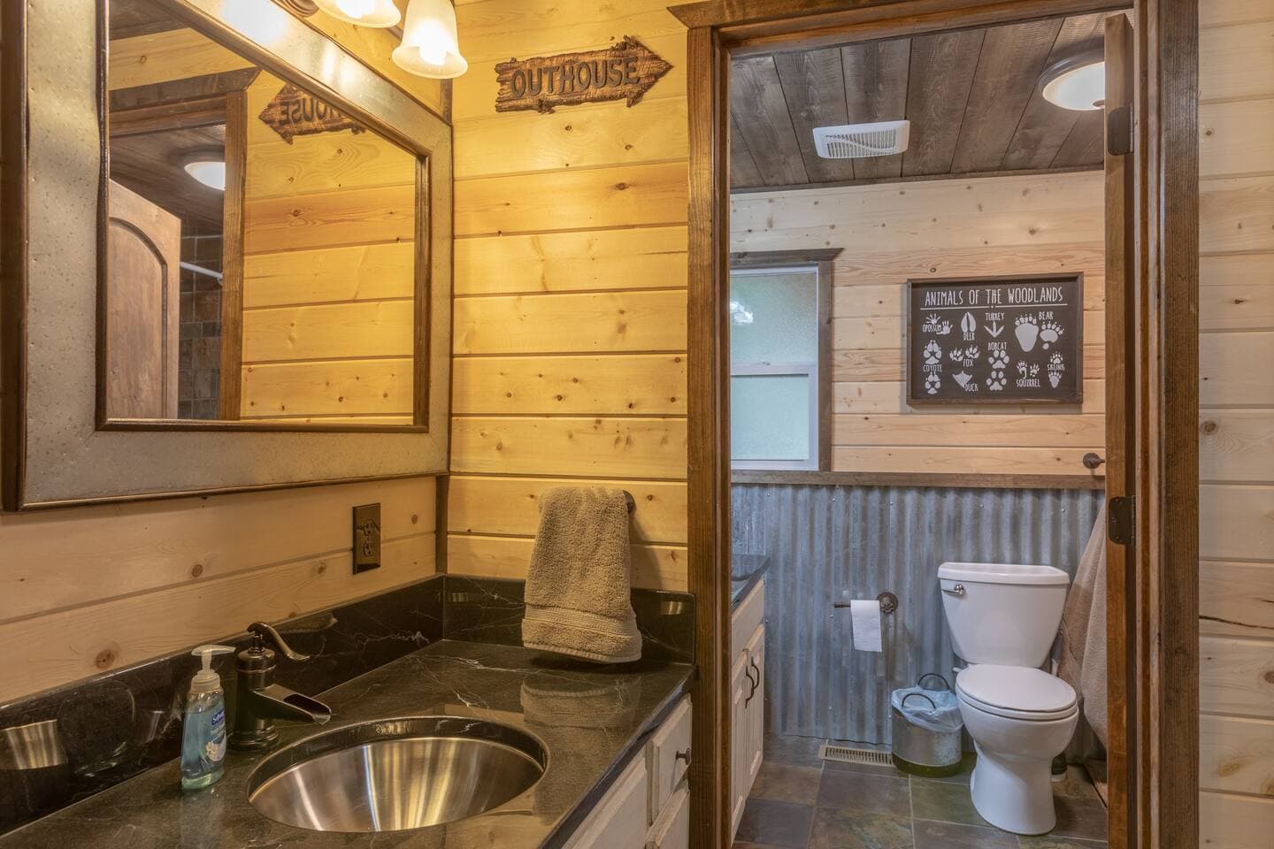 Downstairs full bathroom with rustic touches and upgraded countertops.