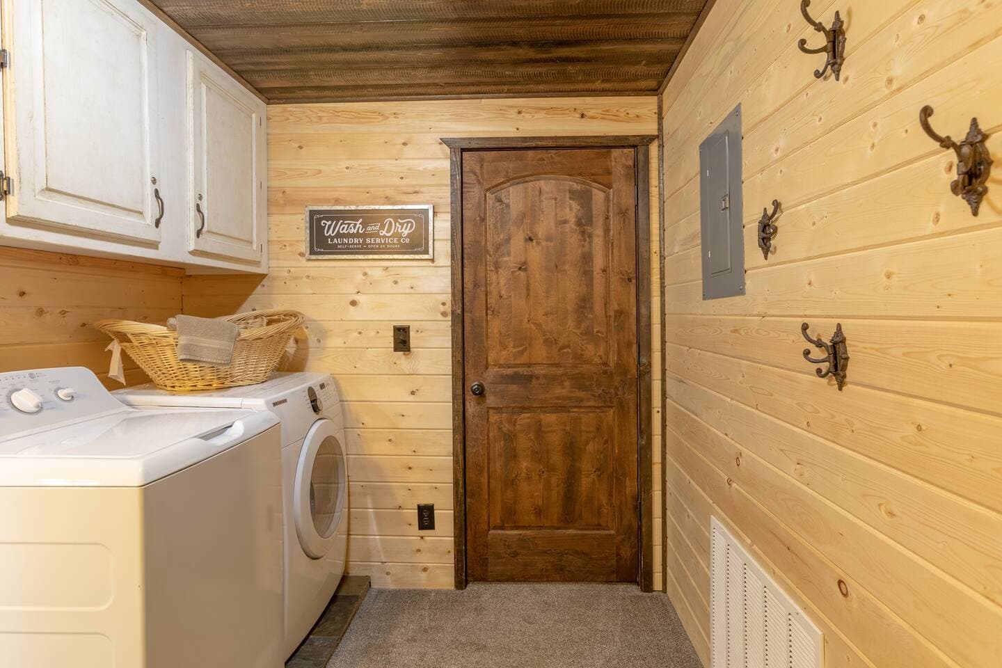 Spacious laundry room with drying hooks for towels or clothes.