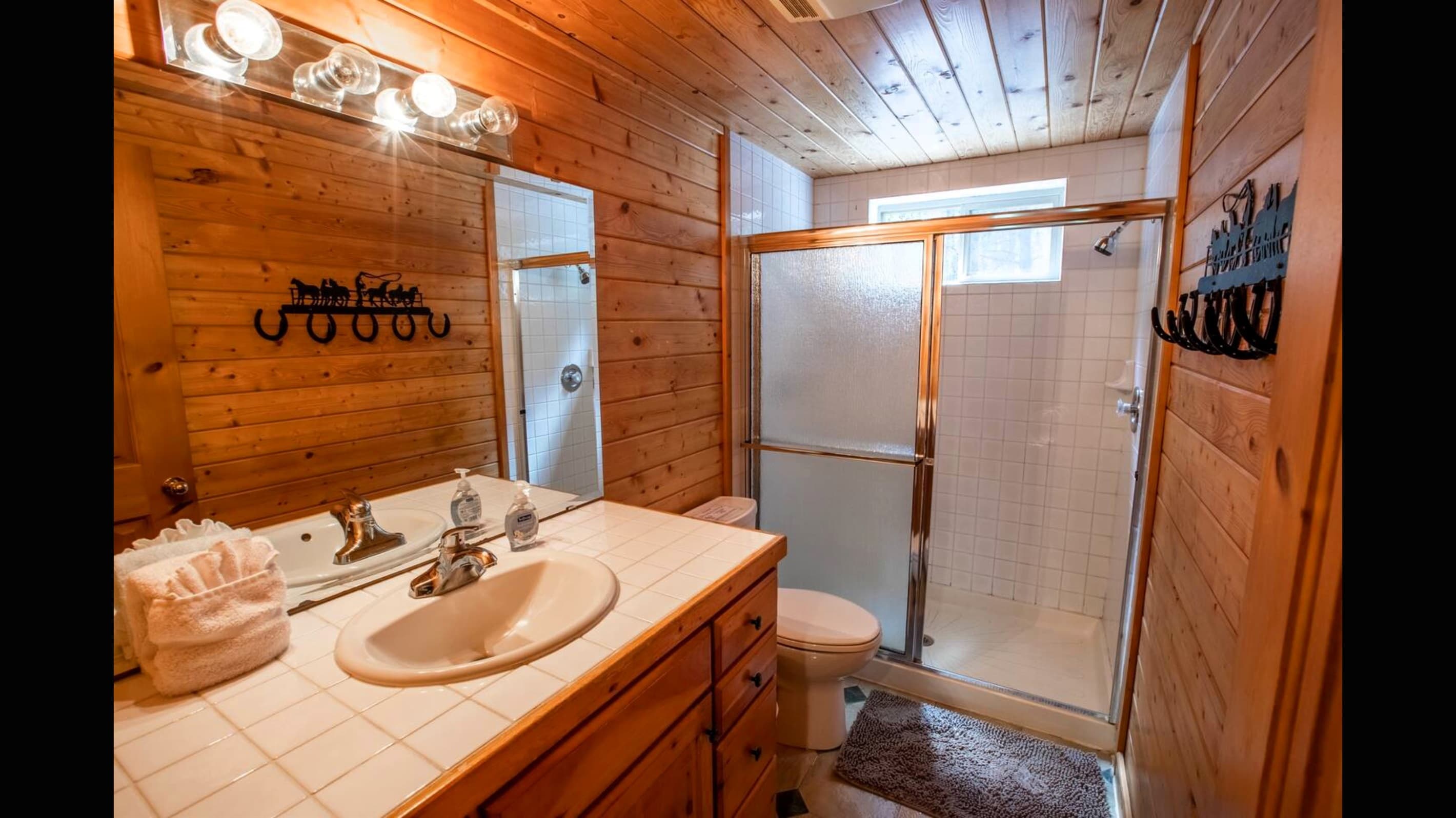 The second bathroom for the second and third room uses with walk-in shower and plenty of counter space.