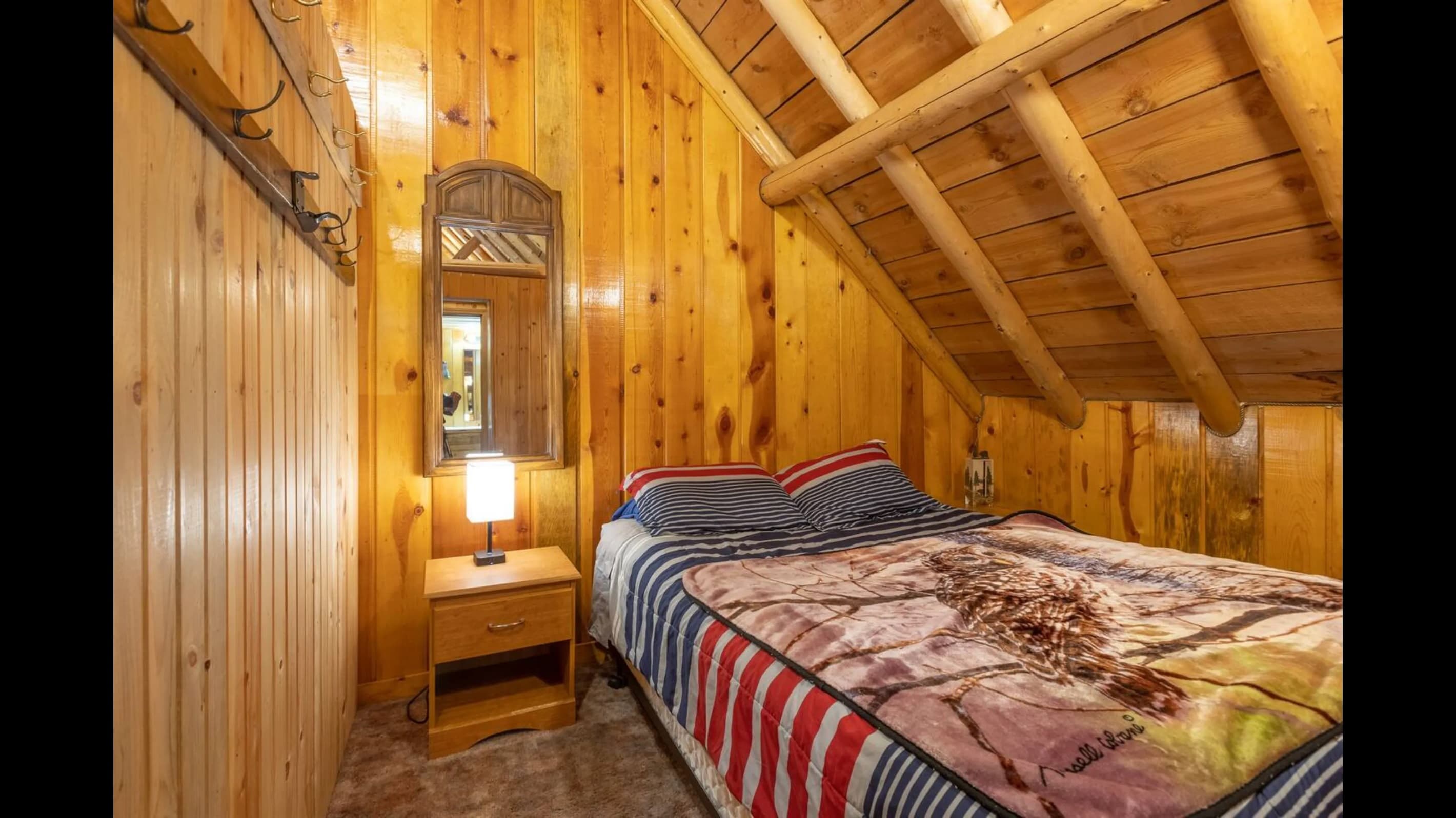There is a queen bed in the north east corner bedroom upstairs.