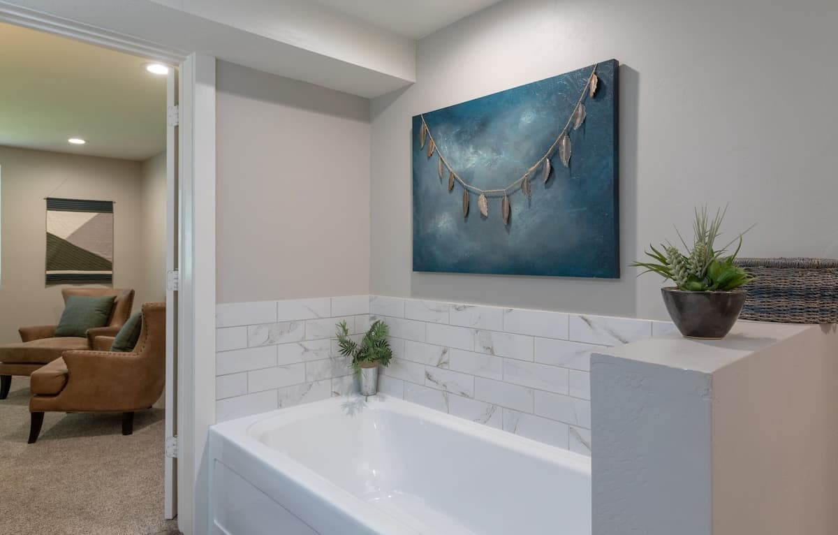 Beautiful primary suite features a soaking tub and tiled shower.