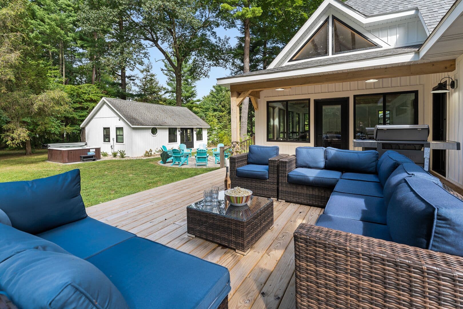 The west deck faces toward the lake. Large Weber grill, right rear.