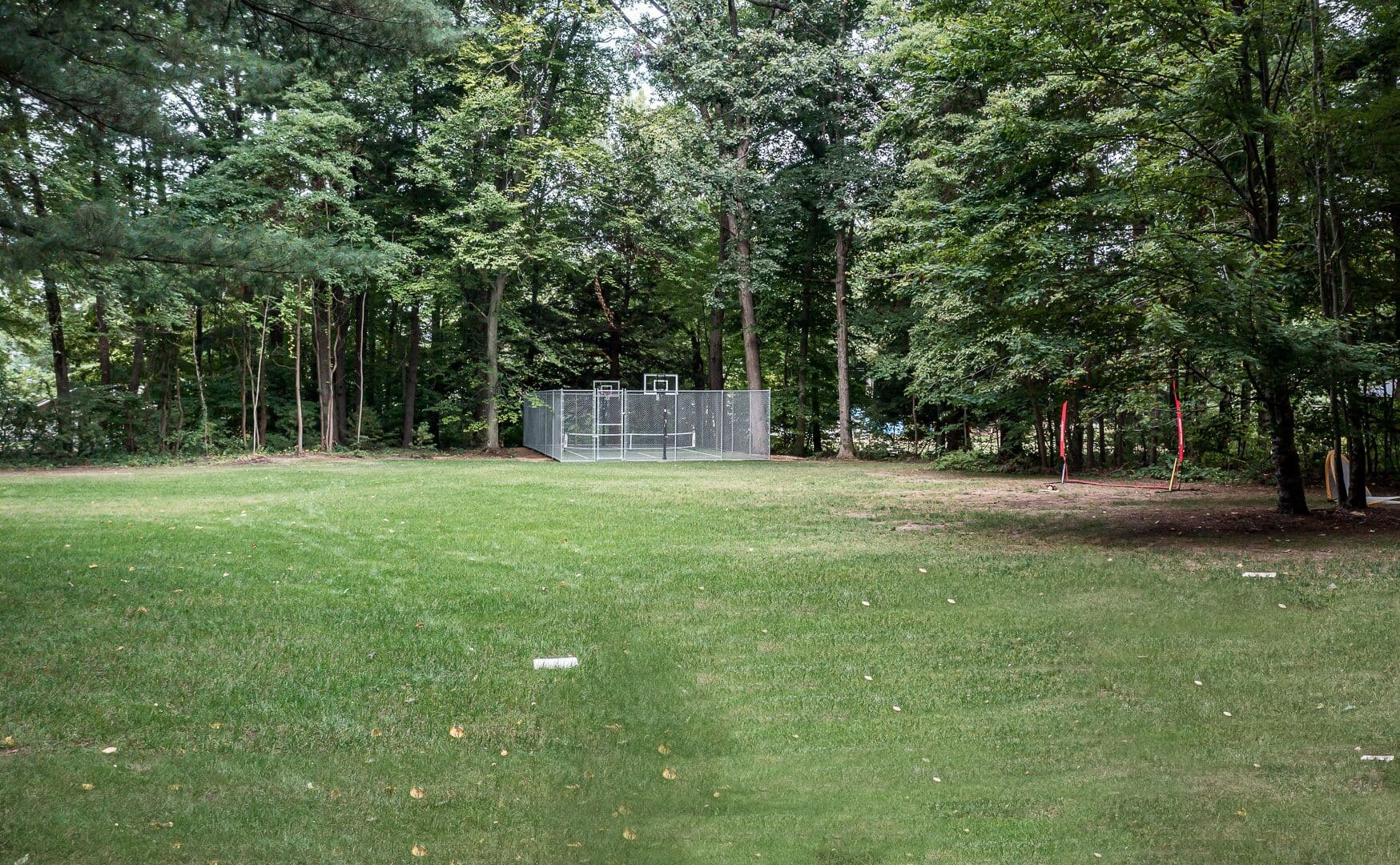 The pickleball court is in the back yard on the way to the beach.
