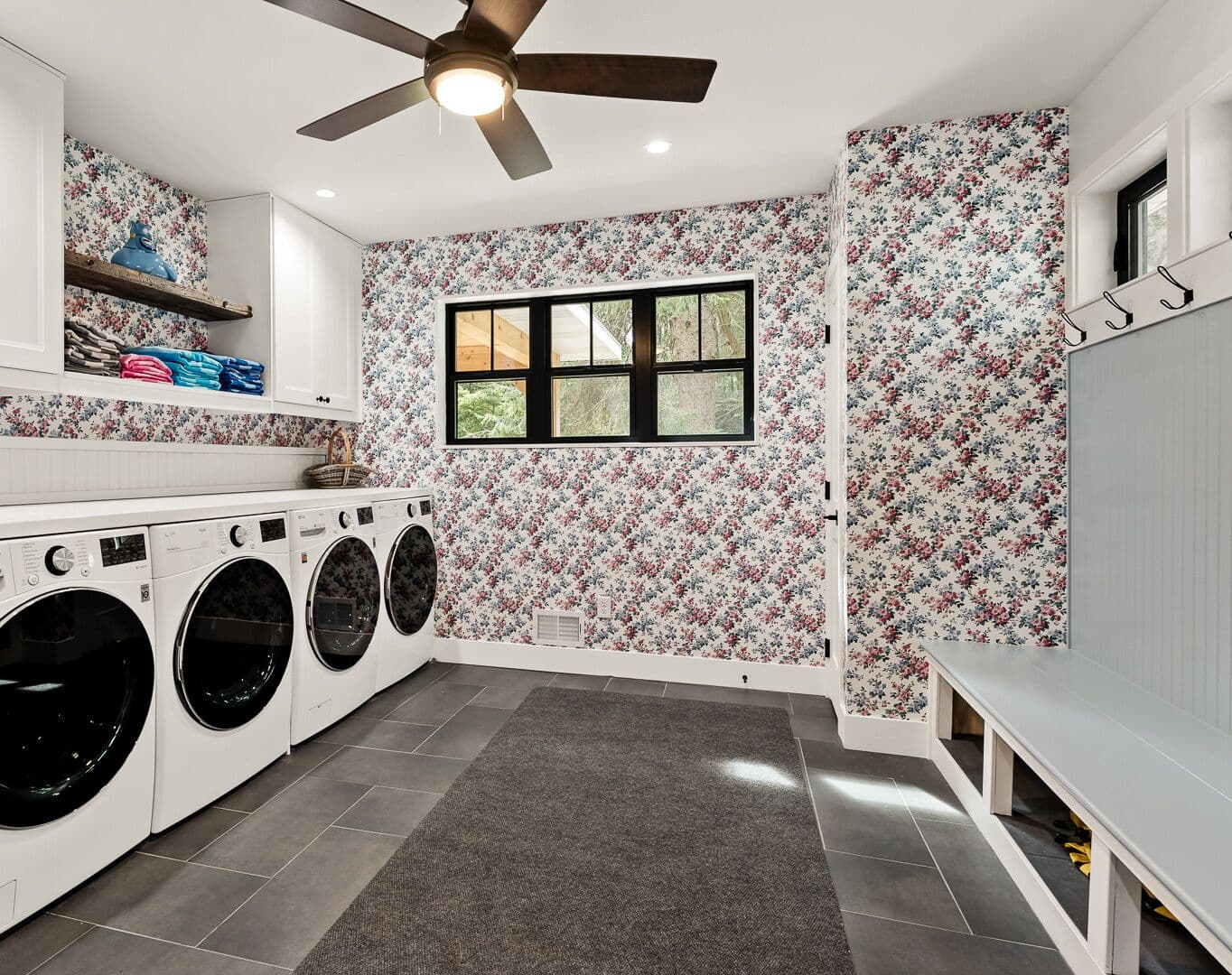 Large laundry room with second refrigerator, two washers and dryers