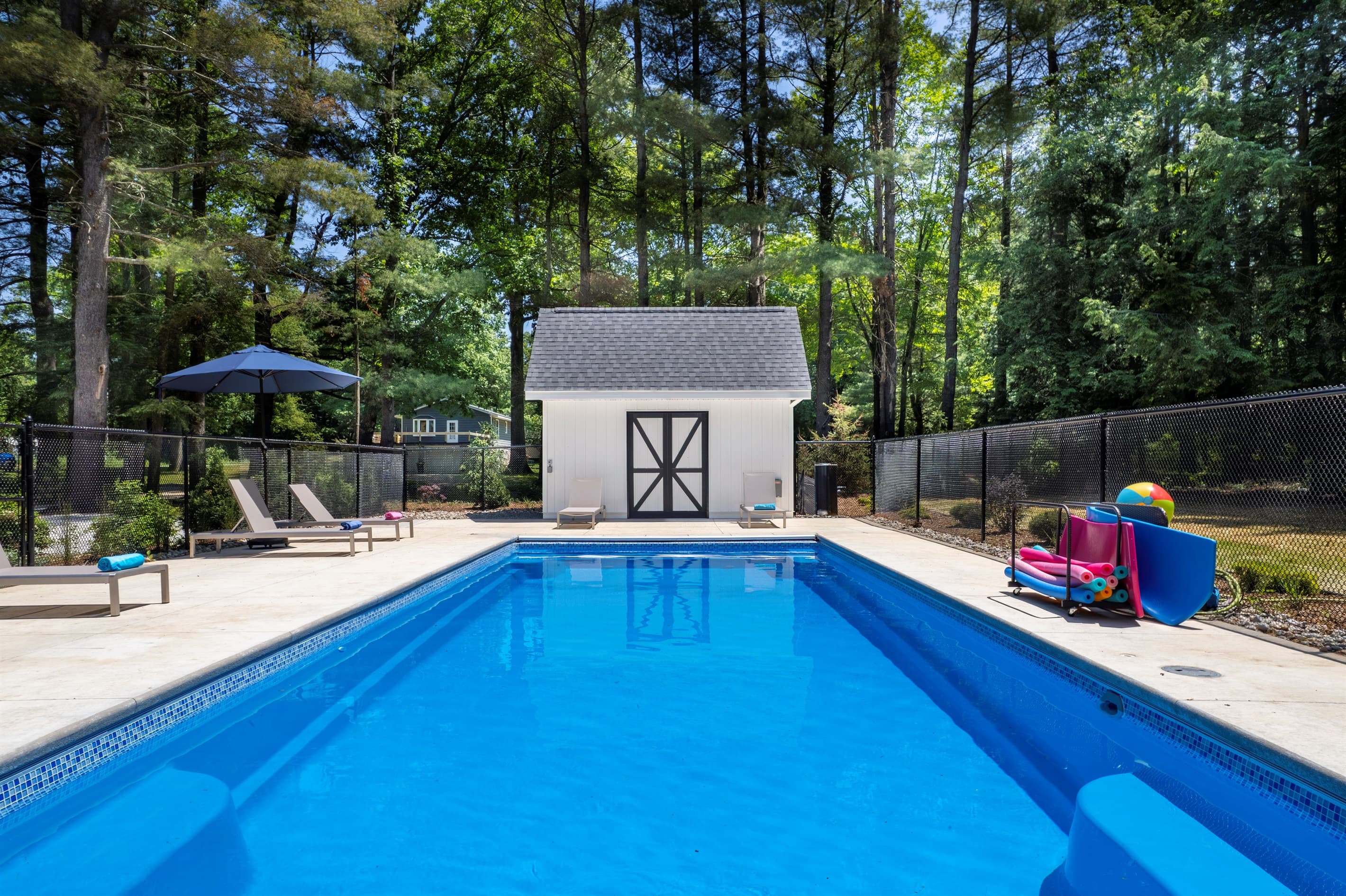 Fenced-in swimming pool with room to lounge in the sun