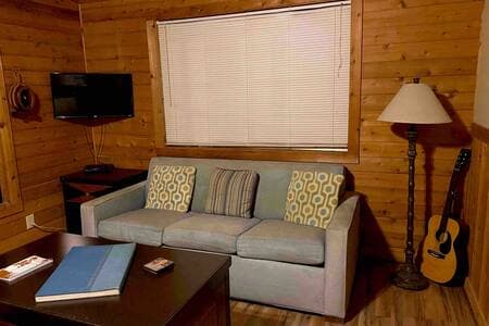The living room features a queen size convertible sleeper sofa bed.