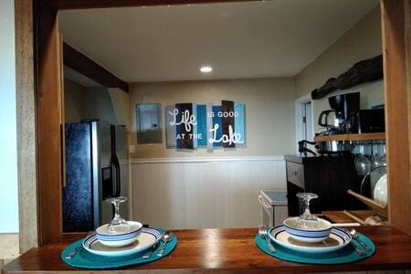 Indoor dining area for 2 including barstools and kitchen passthrough for easy serving and clean up.