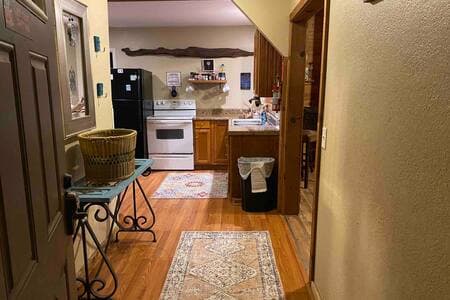 The entrance leads to the open kitchen stocked with cookware, silverware and most common dinner ware