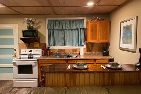 Stove, microwave, mini fridge, coffee maker (grounds) cooking and dining utensils utensils and wares