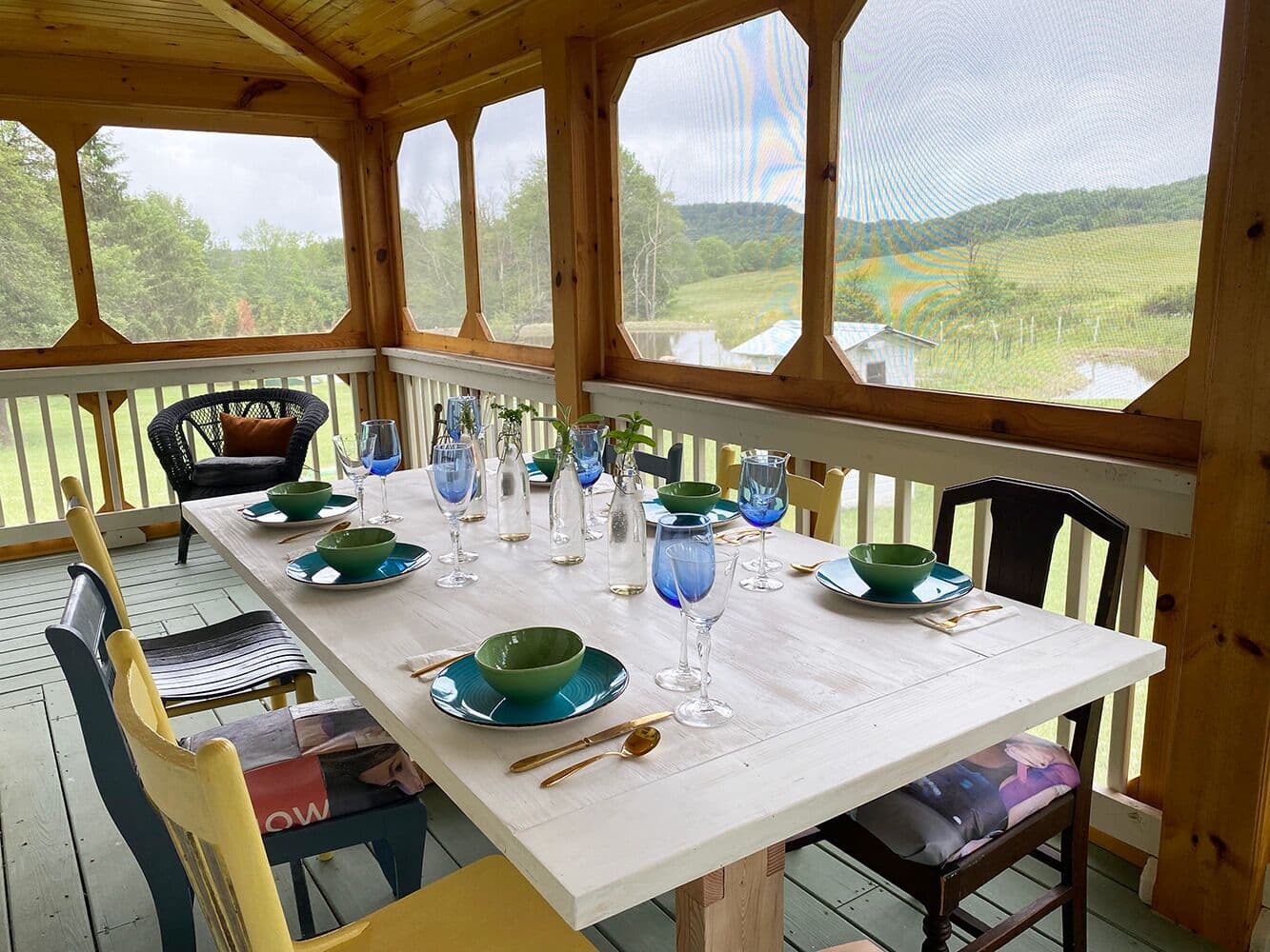 Dine in the screened-in porch, at the outdoor picnic table handmade by Bruce