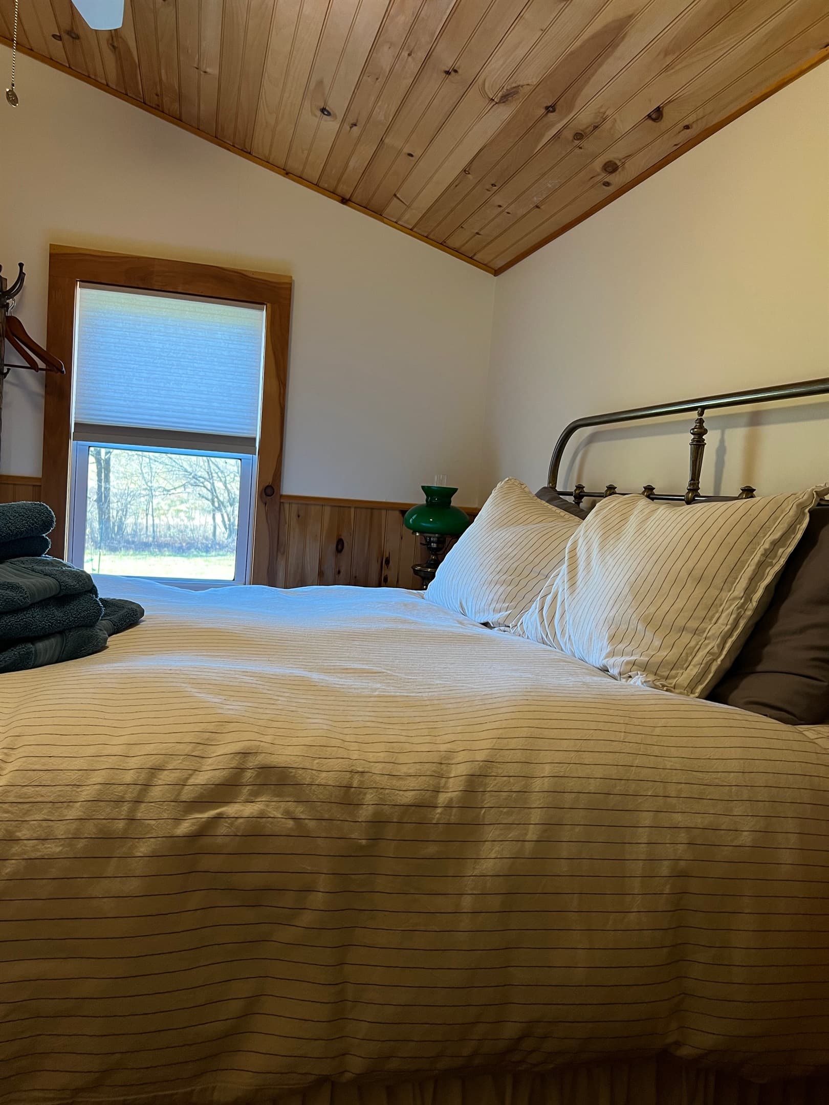 first floor queen bedroom with view of the side yard