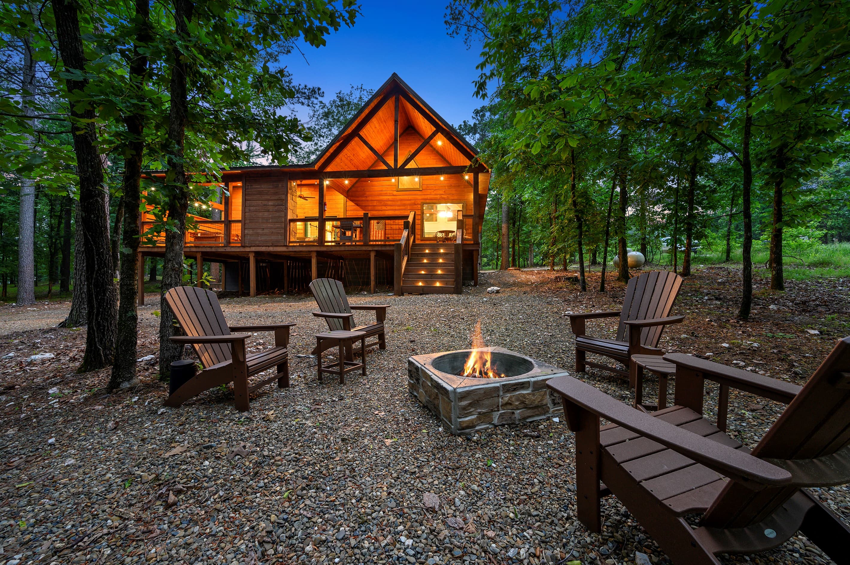 View of the spacious back porch, softly lit for a peaceful setting—perfect for unwinding in this cozy cabin